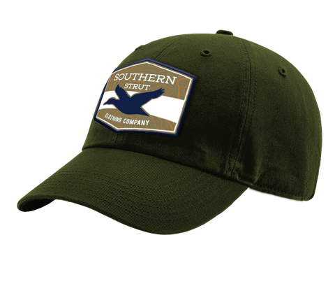 A forest Southern Strut original hat with a hexagon patch with a top and bottom brown strip and a white one separating it. At the top "Southern Sturt," underneath that a silhouette of a duck. 